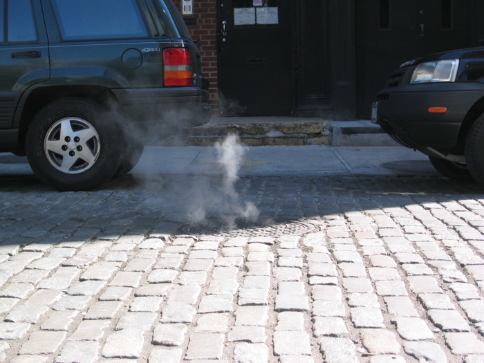 Steam rising from a New York manhole cover