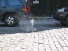 Steam rising from a New York manhole cover