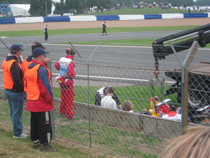 David Coulthard attends to his stricken Red Bull motor car